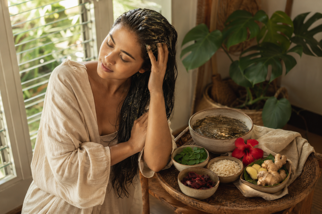 Natural herbal hair care ritual using botanical ingredients in a bright minimalist home.